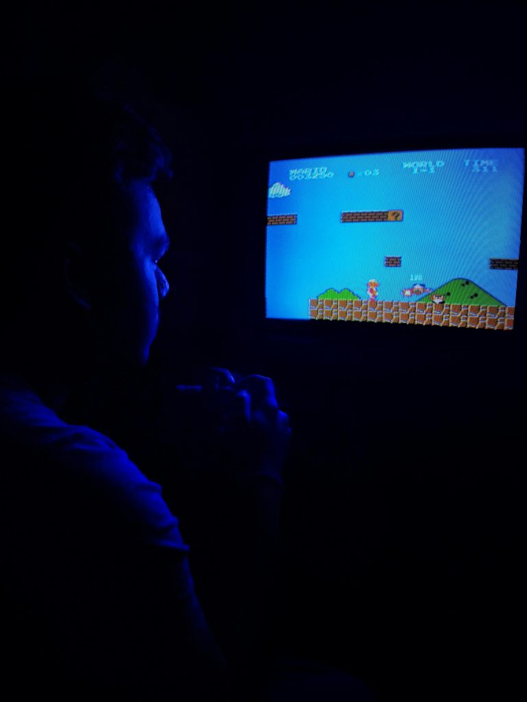 Photo of Man Playing Super Mario Bros